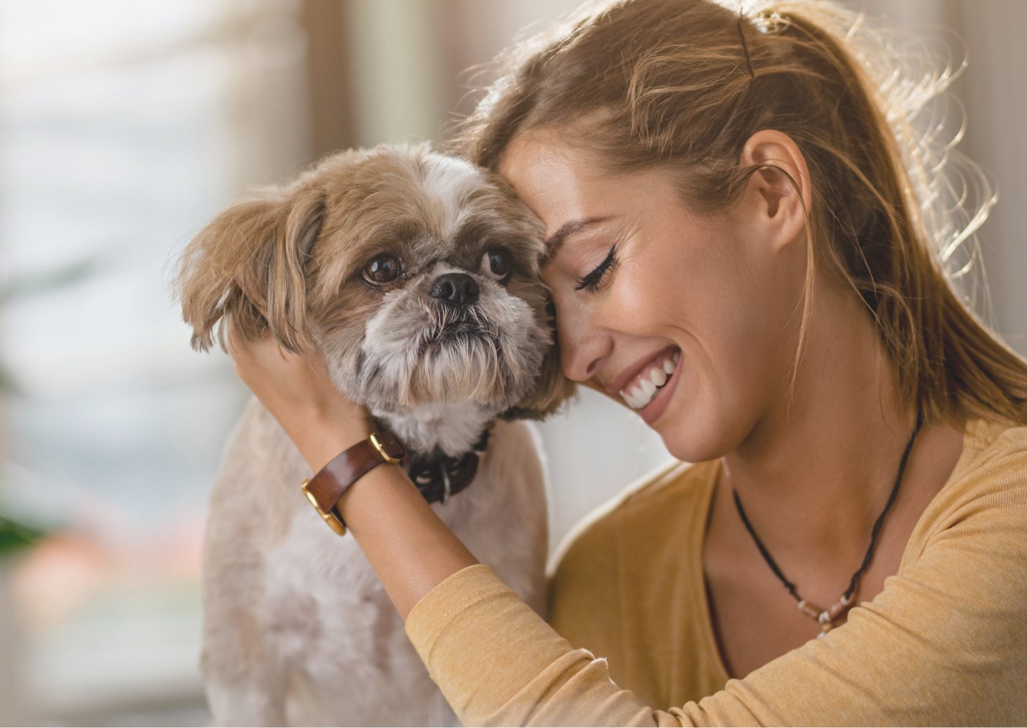 Woman hugging a small dog